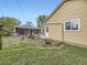 Backyard featuring a fire pit area, grass, and access to the detached garage at 5721 Everett St, Arvada, CO 80002