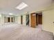 Finished basement with neutral carpet and mirrored closet doors, perfect for a rec room at 5721 Everett St, Arvada, CO 80002