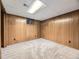 Finished basement featuring paneled walls and neutral carpeting at 5721 Everett St, Arvada, CO 80002