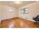 Bright bedroom featuring hardwood floors and two windows that bring in ample natural light at 5721 Everett St, Arvada, CO 80002