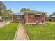 Charming brick home with a well-maintained front yard and inviting walkway at 5721 Everett St, Arvada, CO 80002
