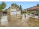 Detached two-car garage with a concrete driveway and covered patio in the background at 5721 Everett St, Arvada, CO 80002