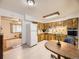 Spacious kitchen featuring wooden cabinets, white appliances, and open layout at 5721 Everett St, Arvada, CO 80002