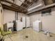 Basement laundry room with washer, dryer, utility sink and storage at 5721 Everett St, Arvada, CO 80002