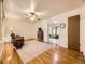 Cozy living room with hardwood floors, ceiling fan, and open view to dining area at 5721 Everett St, Arvada, CO 80002