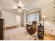 Bright living room featuring hardwood floors, large window, and comfortable seating area at 5721 Everett St, Arvada, CO 80002