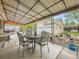 Covered patio with wrought iron furniture, string lights, and detached garage at 5721 Everett St, Arvada, CO 80002