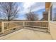 Back patio area with white railing, perfect for relaxing and enjoying the outdoor views at 6295 Clayton Cir, Frederick, CO 80530