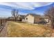 Well-maintained backyard with a lawn, fence, and views of neighboring houses at 6295 Clayton Cir, Frederick, CO 80530