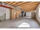 Unfinished basement space with concrete floor, exposed ceiling, and doorway leading to potential additional rooms at 6295 Clayton Cir, Frederick, CO 80530