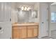 Bathroom featuring double vanity, ample lighting, and access to other rooms at 6295 Clayton Cir, Frederick, CO 80530