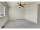 Bedroom featuring plush carpet, a ceiling fan, and a bright window at 6295 Clayton Cir, Frederick, CO 80530