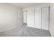 Bright bedroom featuring neutral paint, carpet, closet, and a doorway leading to other parts of the house at 6295 Clayton Cir, Frederick, CO 80530