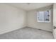 Simple bedroom with plush carpet and a well-lit window at 6295 Clayton Cir, Frederick, CO 80530