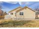 Exterior view of the home featuring a backyard, patio, and neutral-colored siding at 6295 Clayton Cir, Frederick, CO 80530