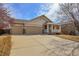 Exterior view showcasing a three-car garage and covered porch at 6295 Clayton Cir, Frederick, CO 80530