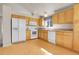 Well-equipped kitchen featuring wood floors, appliances, and ample storage at 6295 Clayton Cir, Frederick, CO 80530