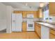 Kitchen showcasing white appliances, wood cabinets and lots of natural light at 6295 Clayton Cir, Frederick, CO 80530