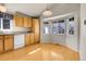 Kitchen with wood cabinets, modern lighting, and a bay window at 6295 Clayton Cir, Frederick, CO 80530