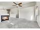 Bright, airy living room with plush carpet, fireplace, and an open layout at 6295 Clayton Cir, Frederick, CO 80530