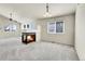 Open-concept living area with plush carpet, a modern fireplace, and stylish lighting at 6295 Clayton Cir, Frederick, CO 80530