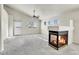 Bright living room with plush carpet, modern fireplace, and ample natural light at 6295 Clayton Cir, Frederick, CO 80530
