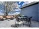Outdoor patio with comfortable seating, a dining table, and beautiful mountain views in the distance at 12344 Turquoise Terrace St, Castle Pines, CO 80108