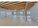 Unfinished basement features exposed wood ceilings, concrete floor, and block walls at 12344 Turquoise Terrace St, Castle Pines, CO 80108
