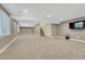 Spacious finished basement with stairs, access door and carpet flooring at 12344 Turquoise Terrace St, Castle Pines, CO 80108