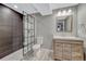 Modern bathroom with unique wood vanity, decorative tile shower and neutral walls at 12344 Turquoise Terrace St, Castle Pines, CO 80108