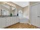 Bright bathroom features wood look floors, dual sinks, granite countertops, and soaking tub with bright natural light at 12344 Turquoise Terrace St, Castle Pines, CO 80108