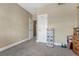 Simple bedroom with beige walls, plush carpeting, and a closet, offering a blank canvas for personalization at 12344 Turquoise Terrace St, Castle Pines, CO 80108