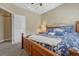 Bedroom featuring neutral walls, plush carpeting, and a wood bed with blue floral bedding and a ceiling fan at 12344 Turquoise Terrace St, Castle Pines, CO 80108