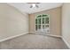 Neutral bedroom features carpet, ceiling fan and a large window with white shutters at 12344 Turquoise Terrace St, Castle Pines, CO 80108