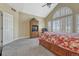 Bright bedroom features vaulted ceiling, large arched window, and comfortable queen bed with drawer storage at 12344 Turquoise Terrace St, Castle Pines, CO 80108