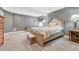 Well-lit basement bedroom showcases a cozy bed, side tables, and ample natural light at 12344 Turquoise Terrace St, Castle Pines, CO 80108