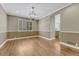 Dining room featuring hardwood floors, modern lighting, and view of the kitchen at 12344 Turquoise Terrace St, Castle Pines, CO 80108