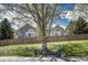 Charming home with a well-maintained yard, wooden fence, and a cozy bench under a mature tree at 12344 Turquoise Terrace St, Castle Pines, CO 80108