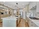 Open kitchen with island, stainless steel appliances and hardwood floors at 12344 Turquoise Terrace St, Castle Pines, CO 80108