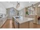 Modern kitchen island with stainless steel appliances and large arched windows with natural light at 12344 Turquoise Terrace St, Castle Pines, CO 80108
