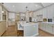 Spacious kitchen features an island, stainless appliances, hardwood floors, and ample cabinets at 12344 Turquoise Terrace St, Castle Pines, CO 80108