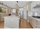 Open concept kitchen with quartz island, stainless appliances, and hardwood flooring throughout at 12344 Turquoise Terrace St, Castle Pines, CO 80108
