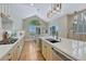 Open kitchen with island, stainless appliances, and a dining area with backyard access at 12344 Turquoise Terrace St, Castle Pines, CO 80108