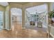 Elegant living room with arched doorways, hardwood floors, and a view of the bright, inviting seating area at 12344 Turquoise Terrace St, Castle Pines, CO 80108