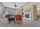 Inviting living room with fireplace, large windows with shutters, and comfortable seating arrangements at 12344 Turquoise Terrace St, Castle Pines, CO 80108