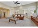 Spacious living room with cozy brown couches and decorative throw pillows offers lots of natural light at 12344 Turquoise Terrace St, Castle Pines, CO 80108