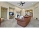 Inviting living room with fireplace, ceiling fan, and seamless flow into the entryway at 12344 Turquoise Terrace St, Castle Pines, CO 80108