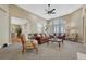 Bright and open living room with large windows, neutral colors, and seamless flow to the dining area at 12344 Turquoise Terrace St, Castle Pines, CO 80108