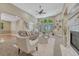 Bright living room with high ceilings, large windows, fireplace, and neutral decor at 12344 Turquoise Terrace St, Castle Pines, CO 80108