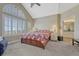 Relaxing bedroom featuring a vaulted ceiling, lots of natural light, and an ensuite bathroom at 12344 Turquoise Terrace St, Castle Pines, CO 80108